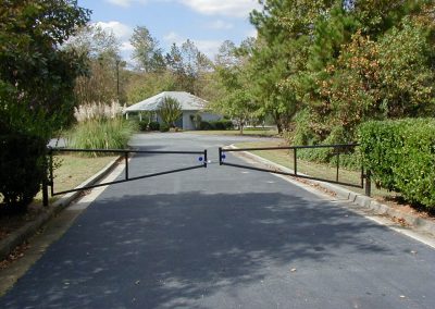 A big size metal gate installed over a concrete road