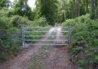 A metal gate installed to block a pathway