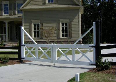 A white low height wooden entry gate