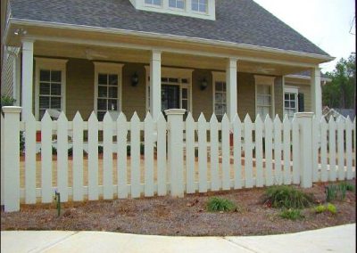 White low-height fencing around a ranch-style house