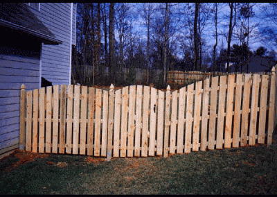 Unpolished wooden plank fencing with gaps