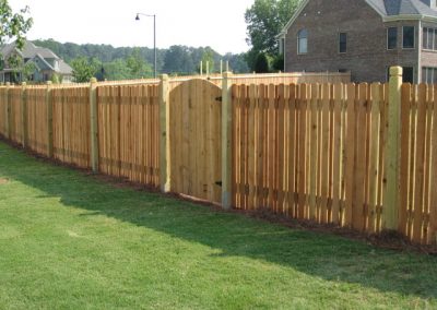 Polished wooden fencing layed over the green grass