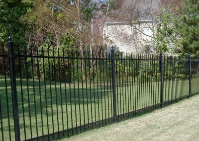 Metal bar fencing with pointed tips around a ground