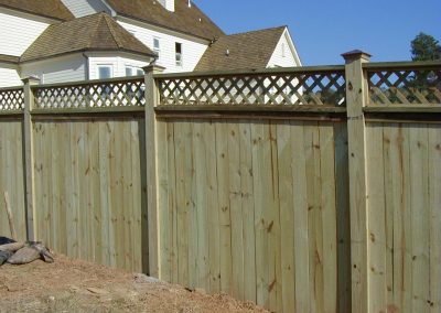 A white wood fencing with cross mesh design on top