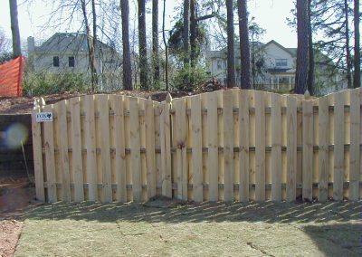 A panel of wooden plank fencing with a triangular top design