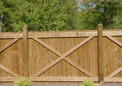 A wooden fencing with additional cross design with white wood