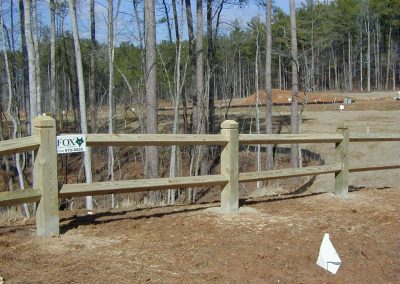 Wooden fencing with wide gaps that indicate land demarcations