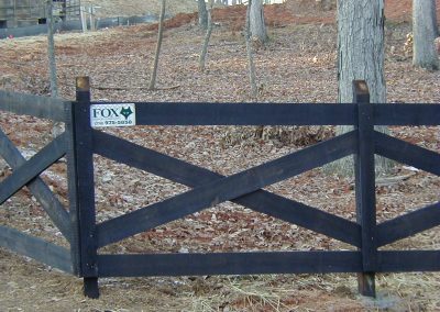 Low height black painted crisscross fencing