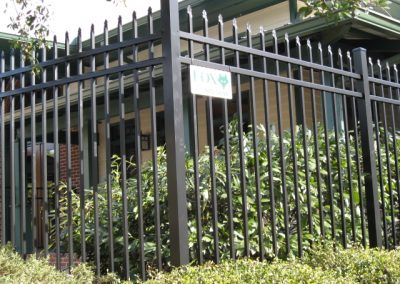 A low angle view of a black painted metal fencing